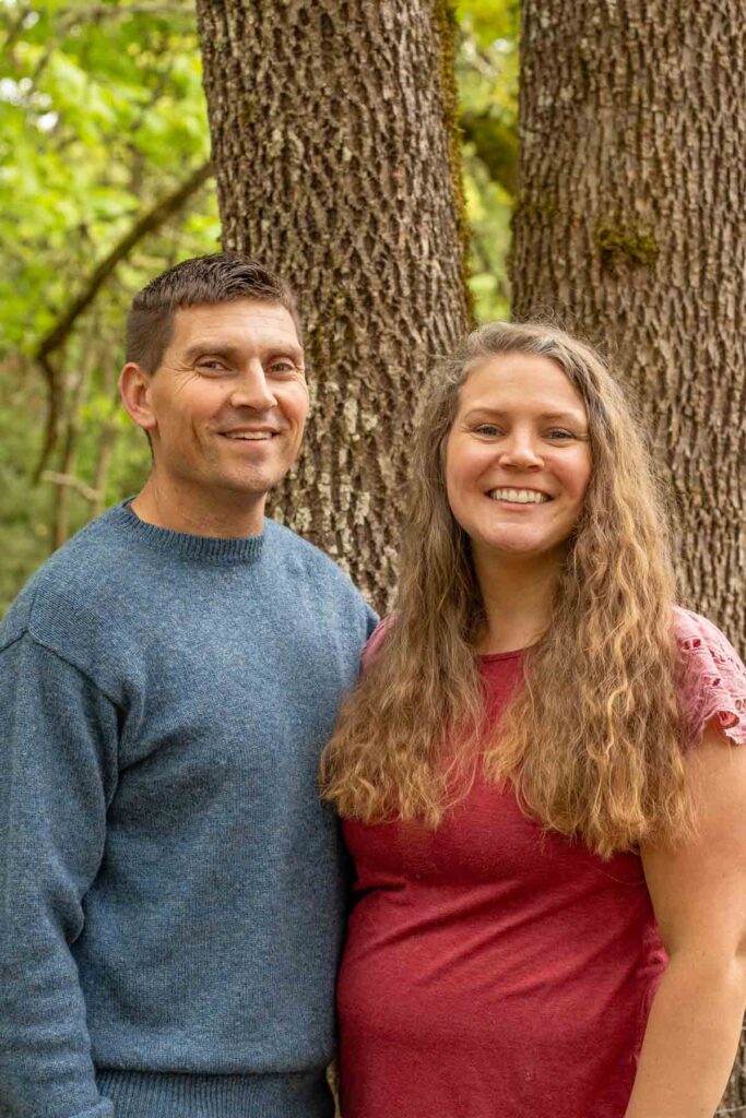 A couple standing in front of a tree.